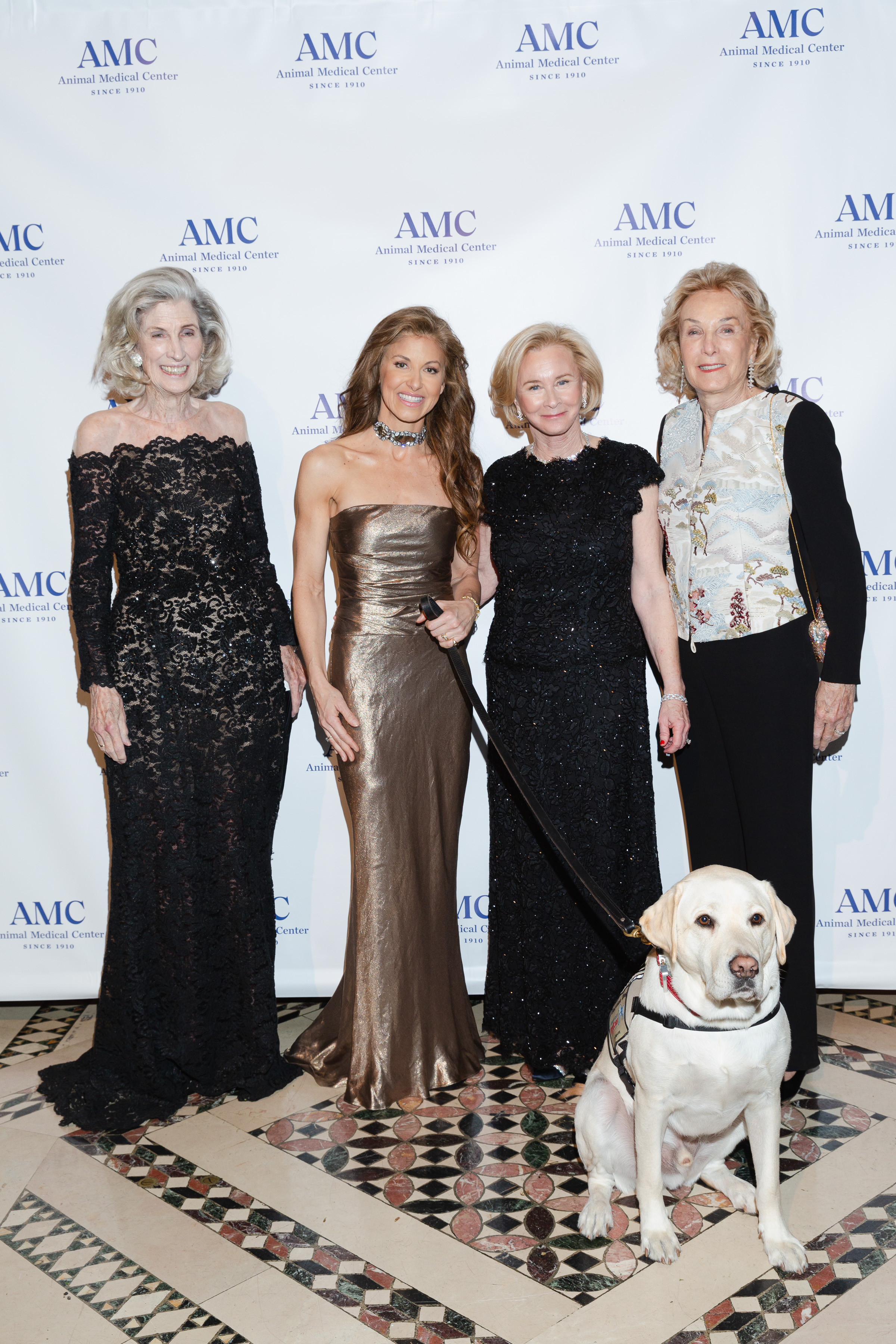 Dylan Lauren and service dog Sully H.W. Bush pose with AMC trustees
