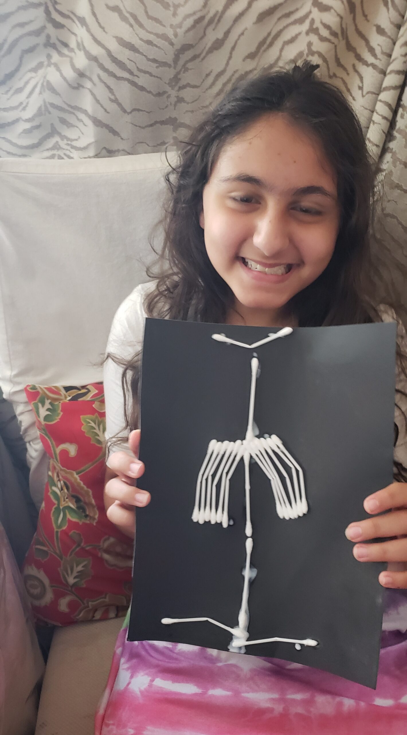 Child posing with x-ray made using household craft materials