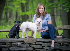 Victoria Schade posing with her two dogs