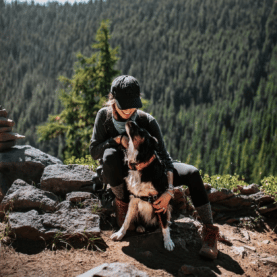 A woman hiking with a dog