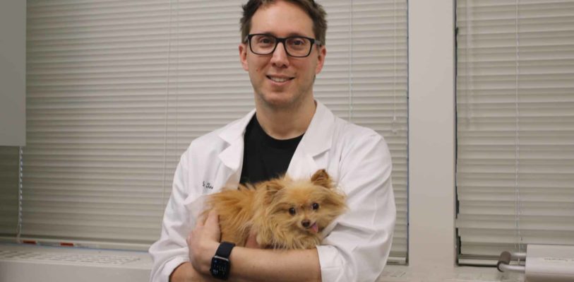 Dr. Carl Toborowsky with a staff dog.